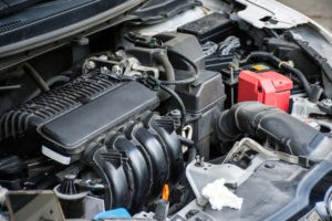 Close-up of mechanic's hands working on an engine, highlighting engine repair and maintenance