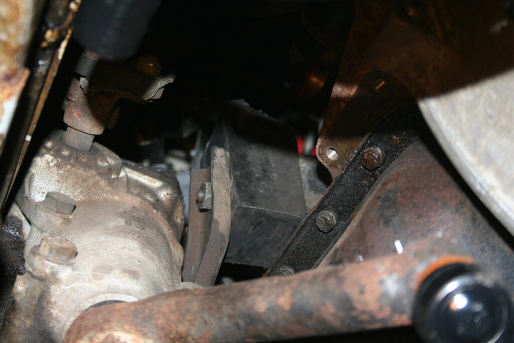 Driver-side engine mount on a 2002, showing its function in supporting the engine.