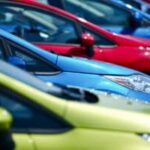 a row of green, blue and red cars