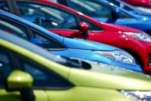 a row of green, blue and red cars