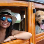 Woman with dog in classic car